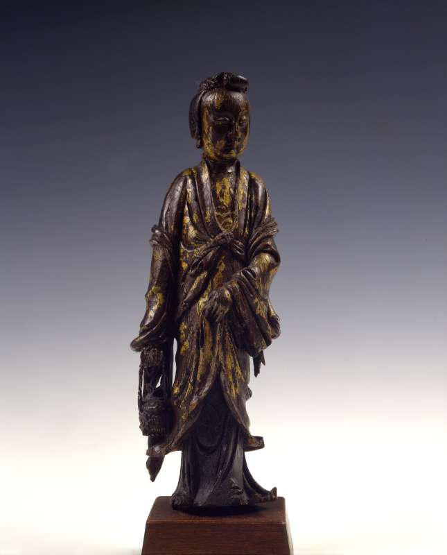 Guanyin, Goddess of Mercy, in the form of Yulan, patron saint of fishermen, carrying a basket with a fish